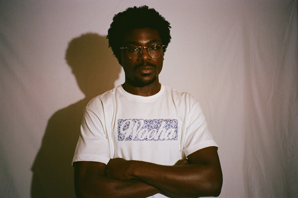 Person wearing a Wooha Blue Tile Tee against a plain background